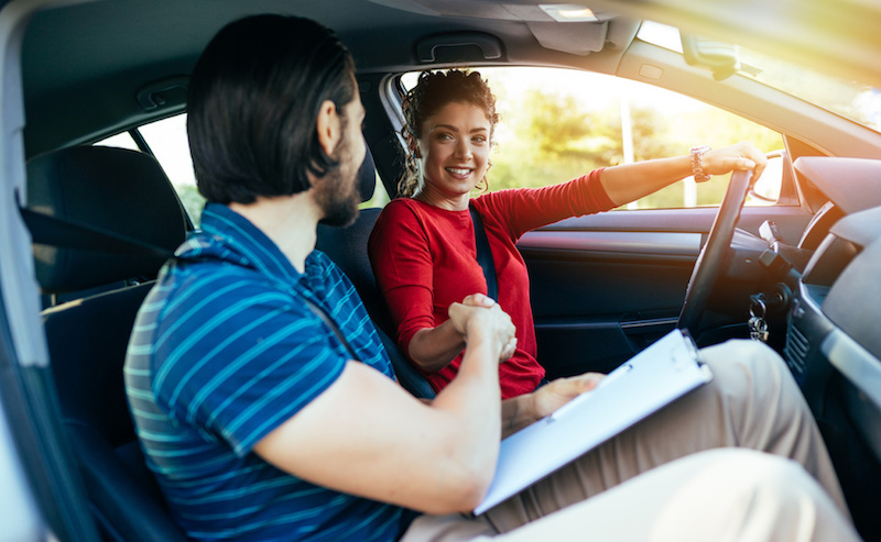 Driving school. Beautiful young woman successfully passed driving school test.